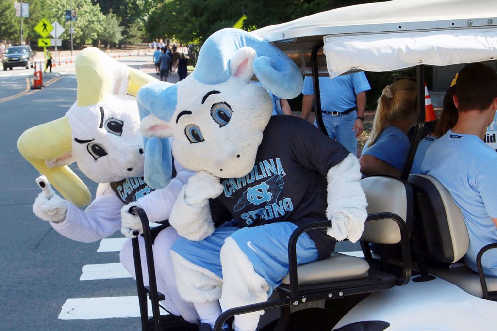 Rameses and Rameses Jr. in a golf cart.
